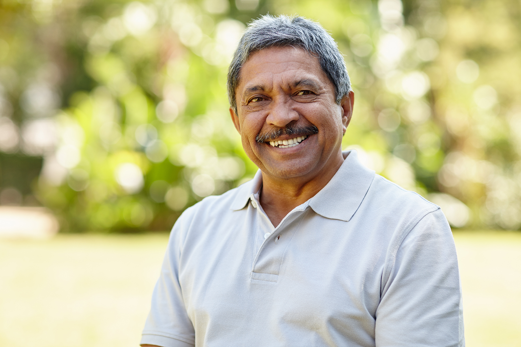 Man smiling after a complete dental exam in Vero Beach, FL