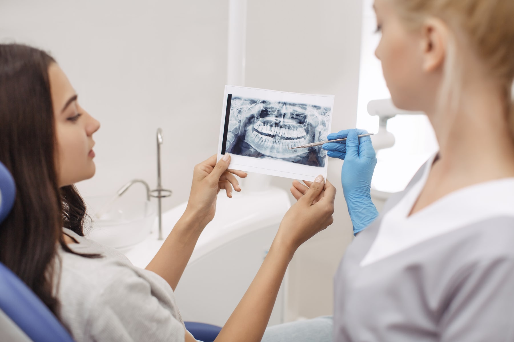 patient learning helpful info from her oral cancer screening from Novak Dental in Vero Beach FL