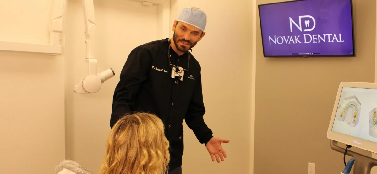 Dentist explaining treatment options to a patient at Novak Dental in Vero Beach, FL