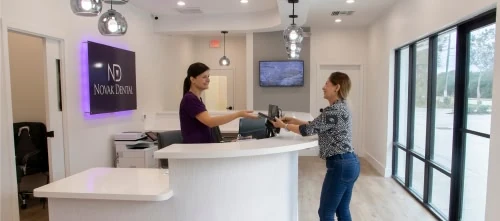 Patient checking in at the Novak Dental front desk in Vero Beach, FL